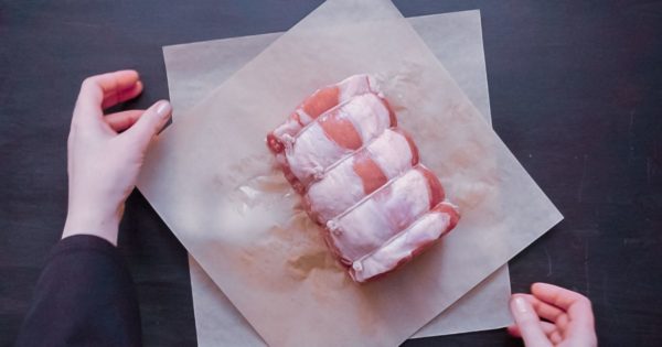 Boneless pork roast on brown butcher paper.